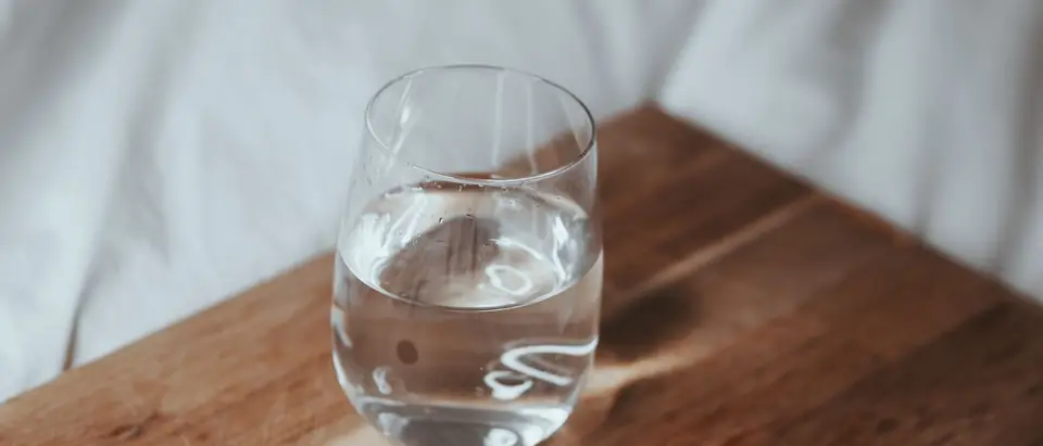 A glass of water on a wooden board