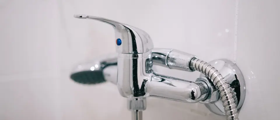 A chrome mixer tap on a white wall