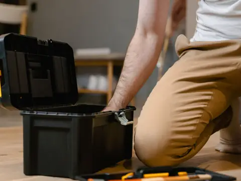 A toolbox opened on the floor for a repair at home