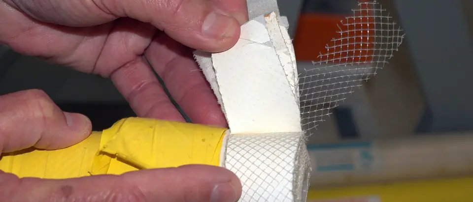 Hands peeling back the wrapped layers of a reverse osmosis membrane element