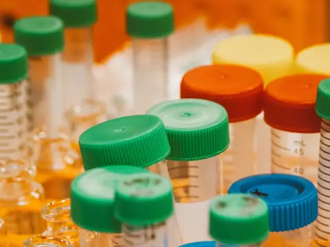 Laboratory sample bottles with green, orange and blue caps